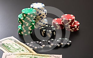 Stacks of poker chips and dollar bills on black background. Poker concept, chips and money