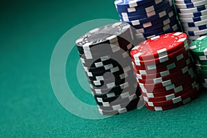 Stacks of poker chips on a green surface.