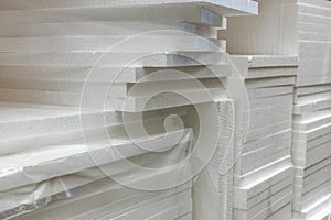 Stacks of polystyrene foam in packaging at a building materials warehouse in a store. The insulation is in the distribution wareho