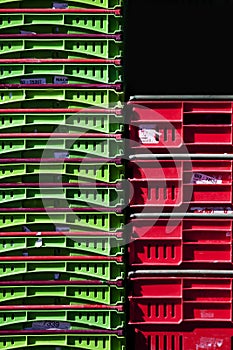 Stacks of Red and Green Plastic Storage Crates