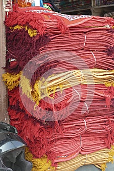 Stacks of red and yellow fabrics at the Ghanta Ghar