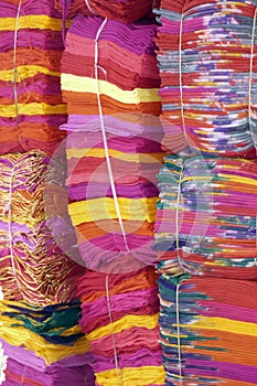 Stacks of red and yellow fabrics at the Ghanta Ghar