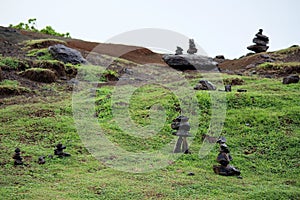 Stacks of Rocks on a Green Hillside