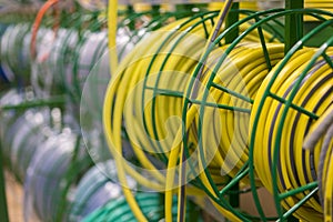 stacks of rolls yellow pvc plastic pipe on the counter in the store. Sale Hoses in the garden of various manufacturers, on shelves