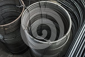 Stacks of rounded steel bars. Also the J shaped steels aside.