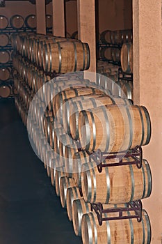 Stacks and rows of wine barrels in spanish wine cellar