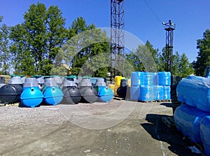 Stacks of septic tanks and other storage tanks at the shipment depot