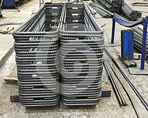 Stacks of small round pipe steel were bended in to rectangle shape. With the straight line steels on the back.
