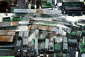 Stacks of steel bars and other construction materials at a construction