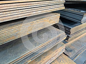 stacks of thick rusted flat metal sheets - close-up