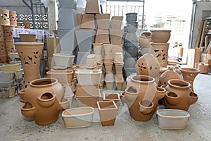 Stacks of various terracotta pots for plants for sale at a garden store