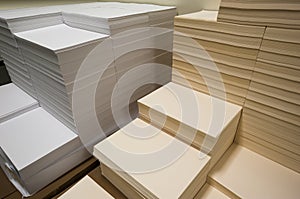 Stacks of white and beige paper
