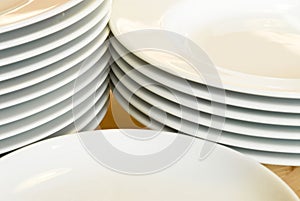 Stacks of white dinner plates