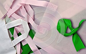 stacks of white, green and pink non-woven tote bags