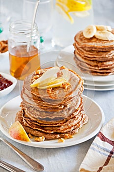 Stacks Of Whole Wheat Pancakes With Apple And Banana Slices