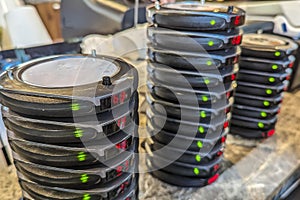 Stacks of wireless restaurant pager, buzzers or beepers at the counter of a cafe. An Electronic Restaurant Guest Paging System