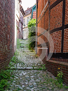 Stade, Germany - August 25, 2019: View at cobbled alley in beautiful historical part  in town of Stade, Germany