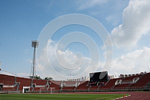 Stadium background with a green grass pitch