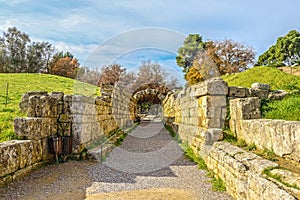 Stadium entrance and exit - Stone walls and arch leaving the field where first olympics took place in Olympia Greece