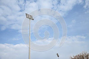 Stadium floodlights, used to lit a sports arena, also called reflectors or projectors, during a sunny afternoon