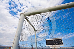 STADIUM - Football field with goal and tablo on blue sky