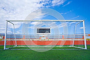 STADIUM - Football field with goal and tablo on blue sky