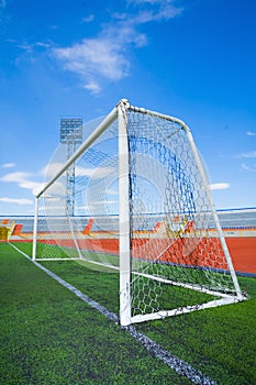 STADIUM - Football field with goal and tablo on blue sky