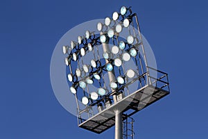 Stadium lights on a blue sky background