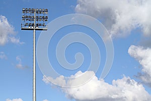 Stadium lights on a blue sky background