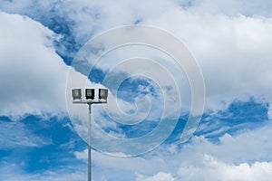 Stadium lights stand alone with blue sky