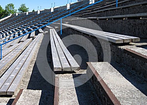 Stadium with a long wooden benches for seats.