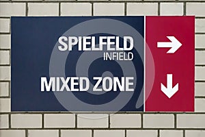 Stadium sign with directional indication for the infield and the Mixed Zone photo