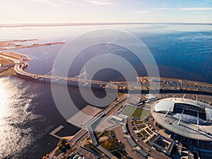 Stadium St. Petersburg. Zenit-Arena. Gulf of Finland. Clear autumn day. Blue sky. Highway. Helipad. Sun glare. Water surface