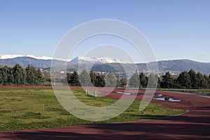 Stadium with view to snowy mountain range of Pindus, Epirus, Greece