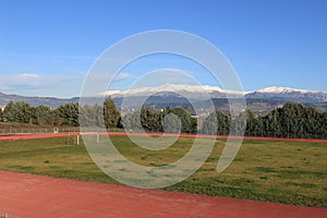 Stadium with view to snowy mountain range of Pindus, Epirus, Greece