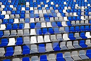 Stadiums amphitheater empty plastic seats in the stadium. Many empty seats for spectators in the stands for football fans and