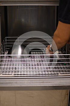 staff cleaning professional cook appliances and ware in professional kitchen