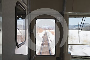 Staff control the speeding train after leaving the valley where the train tracks are covered with snow.