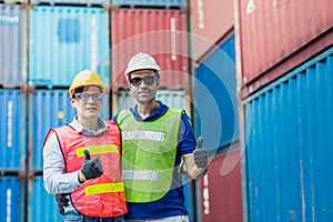 Staff and foreman control loading container cargo working team happy enjoy working standing smile hand show thumbs up