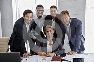 Staff in formal suits pose for corporate picture