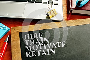 Staff hire, train, motivate and retain written on blackboard