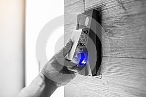 Staff holding a key card to lock and unlock door at home or condominium