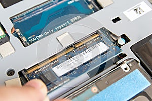 IT staff install DDR RAM into a slot on the mainboard of Laptop