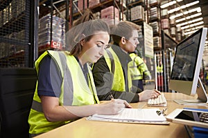 Staff managing warehouse logistics in an on-site office photo