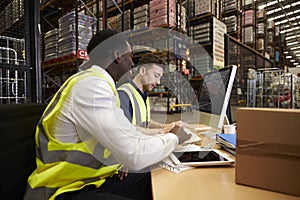 Staff managing warehouse logistics in an on-site office