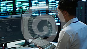 IT staff member in server hub establishing performance benchmarks