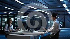 IT staff member in server hub establishing performance benchmarks