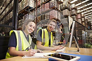 Staff in the office of a distribution warehouse, to camera