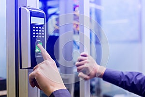 Staff push down electronic control machine with finger scan to access the door of control room or data center. The concept of data photo