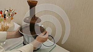 Staff sets up a liquid chocolate fountain.